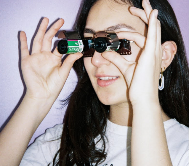 Victoria looking through film canisters