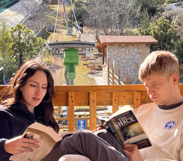 Victoria reading with a friend outdoors