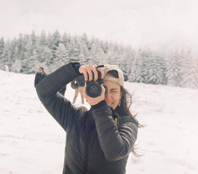 Victoria taking a photo in the snow